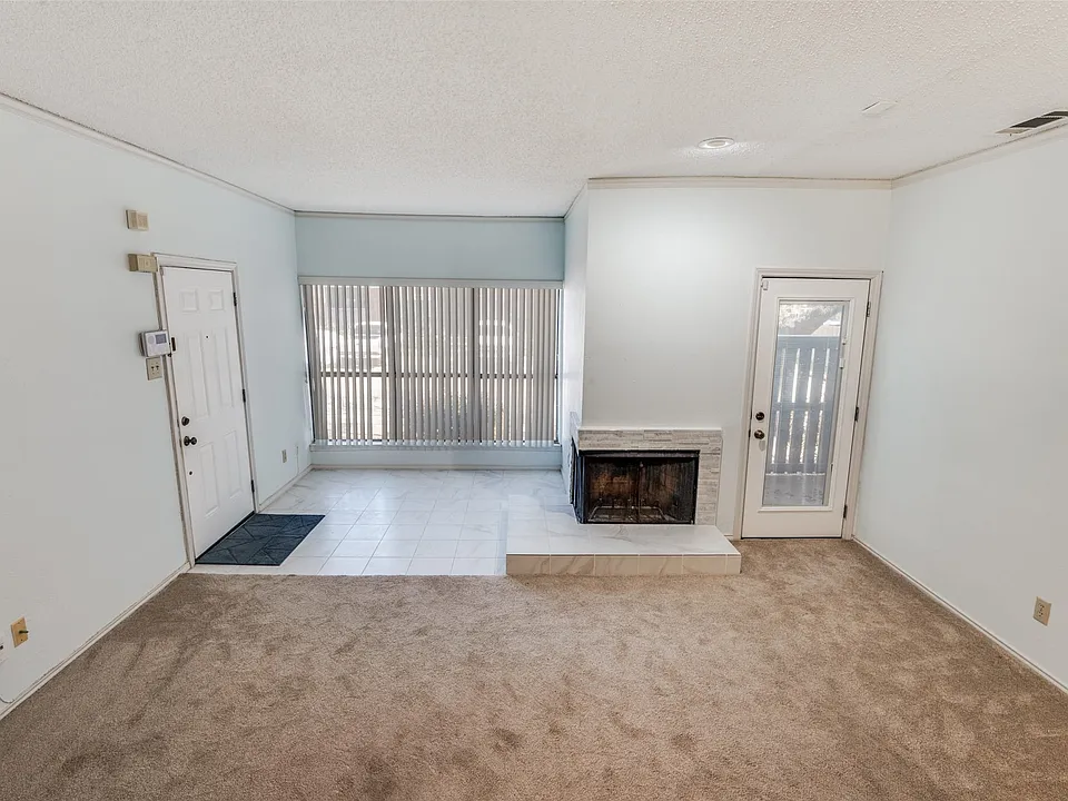 Open layout to dining room with 2 sided wood burning fireplace