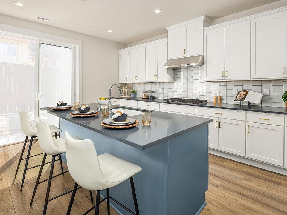 Kitchen features white shaker-style cabinetry