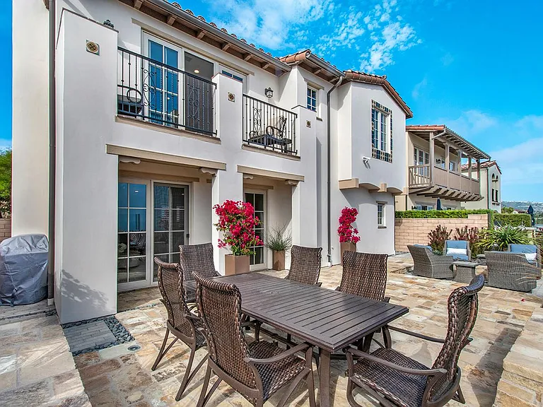 Large open patio with multiple seating areas and ocean views
