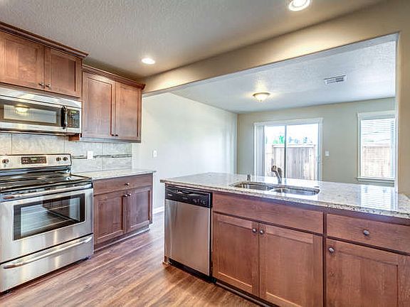 Beautiful flooring, granite counters and wood cabinets