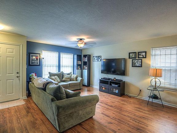 View looking back at the front door. Living room feature large picture window and wood style floorin