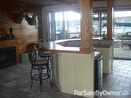 First Floor Entertainment Room
						:
						Features a solid cypress wall, beamed ceiling, & tile floor.