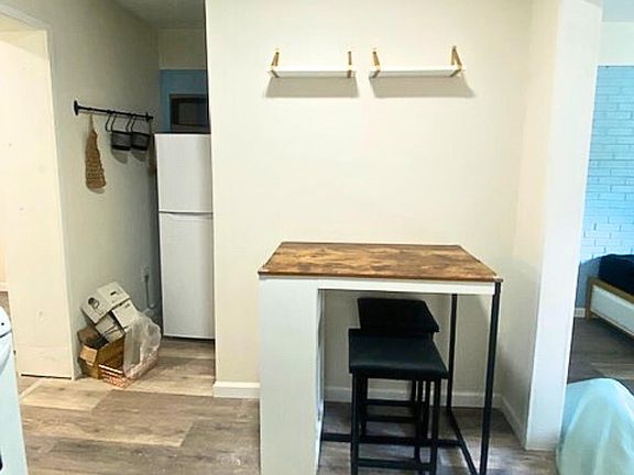 Kitchenette offers bistro table for 2 with storage on the side