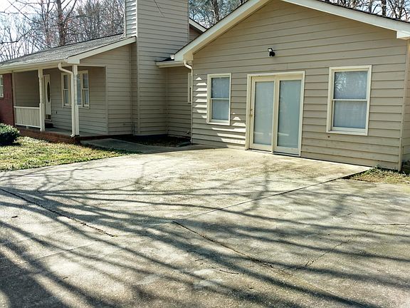 Porch in front and large sundeck with firepit in the back.