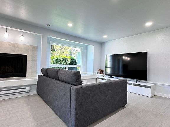 Large open space living room with added LED lighting. 85" Samsung LED TV and IKEA sleeper couch included as part of the rent.