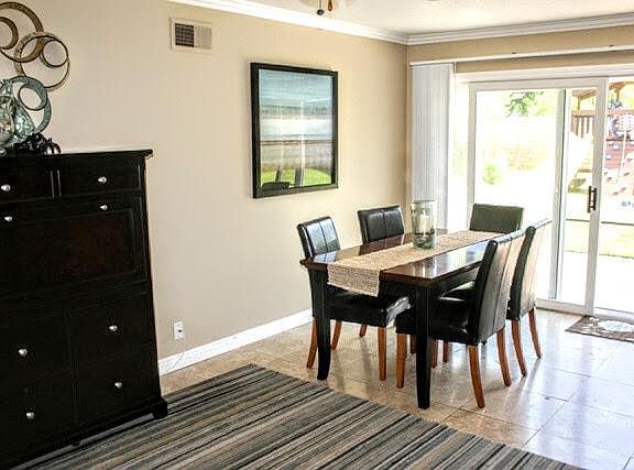 Dining room opens to the kitchen area. Sliding glass door to the backyard.