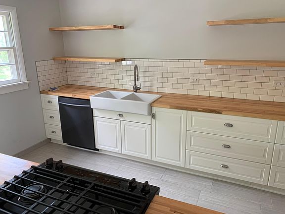 A view into the kitchen from the bar. Lots of counter space and room make cooking and entertaining easy.