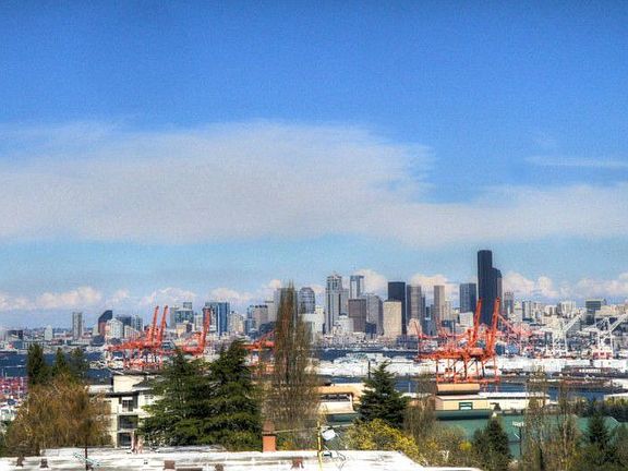 Big views of downtown Seattle, Elliot Bay and the Cascade Range from all living areas of this lovely home.