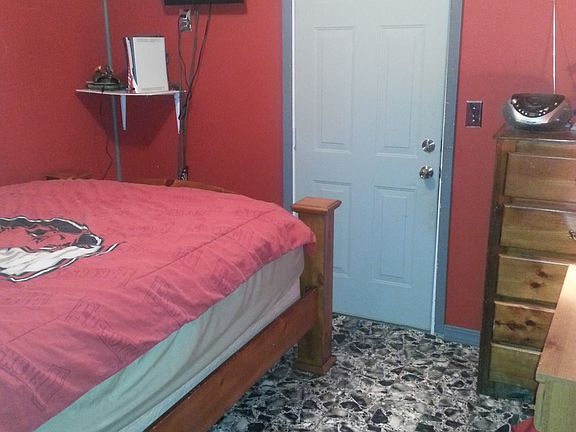 Bedroom with door to carport