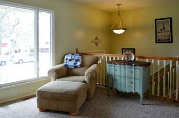 Living room (16x13) features a large window with a view of the front yard and new carpet.  Most of the flooring throughout the home has been recently updated.