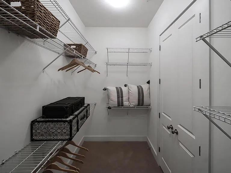 Spacious Walk-In Closet with Wire Shelving and Ample Hanging Space