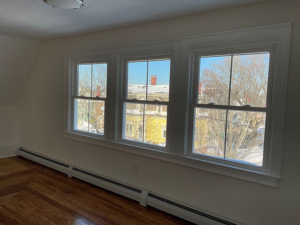 Other angle of large living room windows with views.