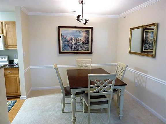 Dining room with new carpet, open airy floor plan.