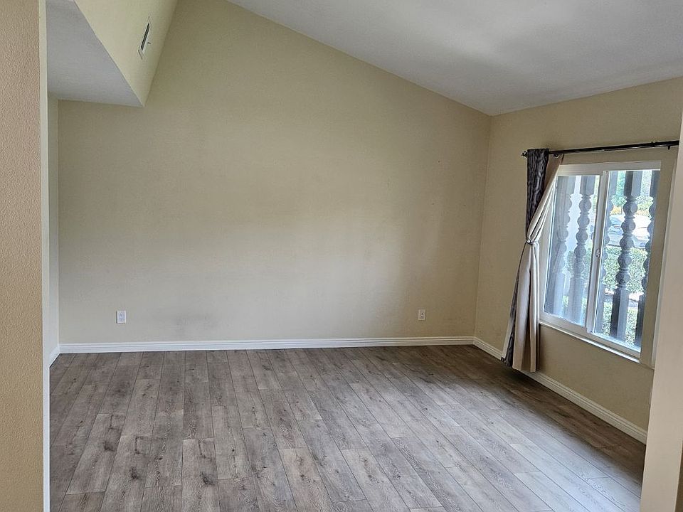 Living room with vaulted ceiling and new flooring.
