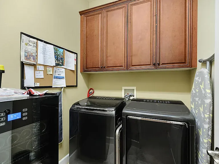 Laundry room with wine fridge