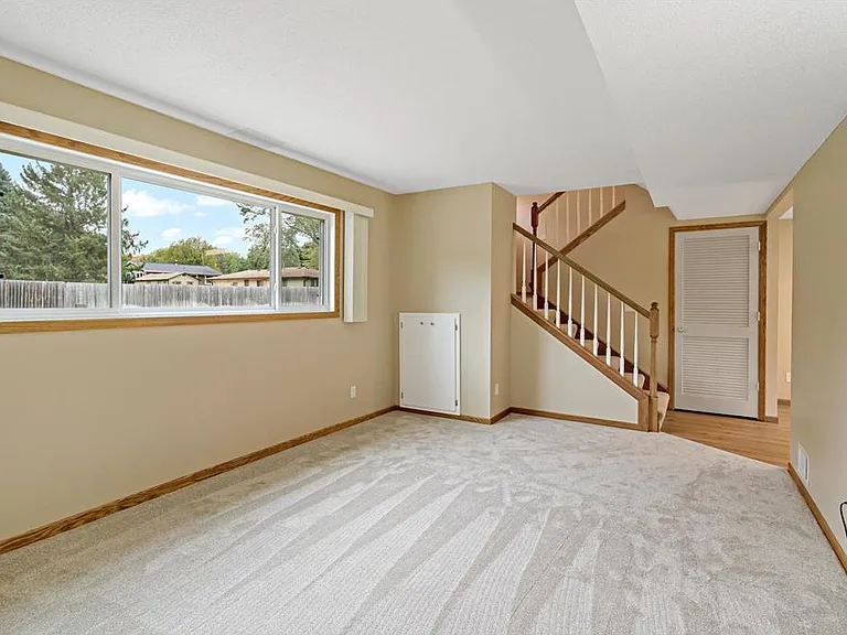 Spacious living room with new carpet and lots of natural light