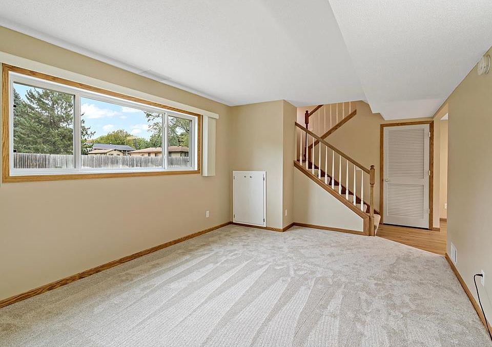 Spacious living room with new carpet and lots of natural light
