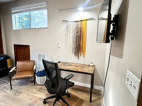 A dedicated workspace with ergonomic chair & overhead lighting