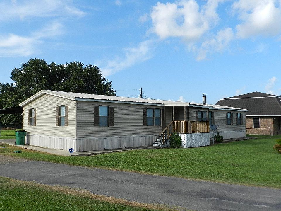 Front entrance opens to foyer (has a large storage closet) just off of living room and den/dining area