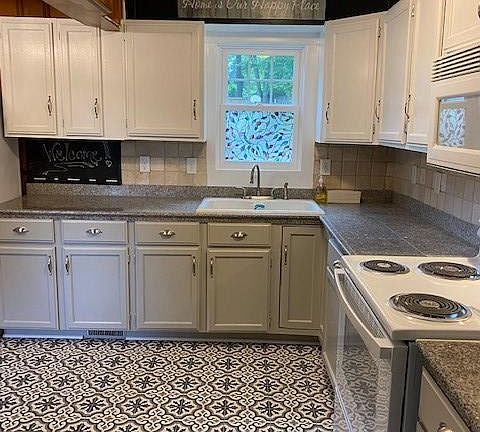 Kitchen- Granite counter top. New stove and tile floor.