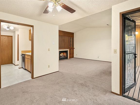 Living, kitchen, dinning room with very large exterior patio that you will fall in love with!  New carpet, paint and blinds through out!