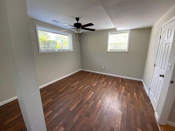 Master bedroom with windows & laminate vinyl flooring. Room measures 11.5' x 14'