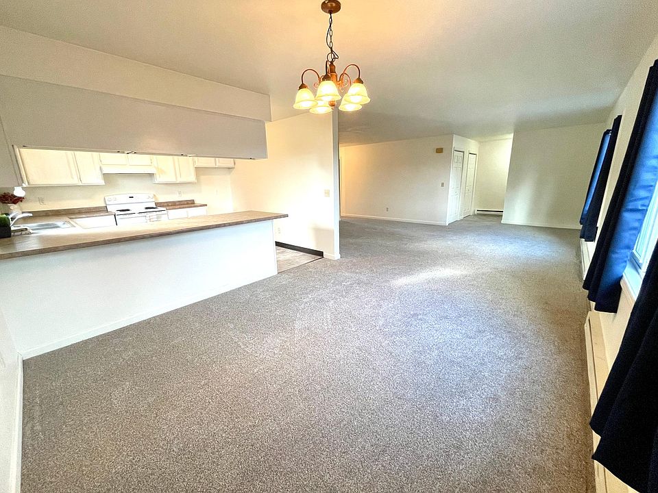 Dining room, kitchen, and living room. Entryway is in the background.