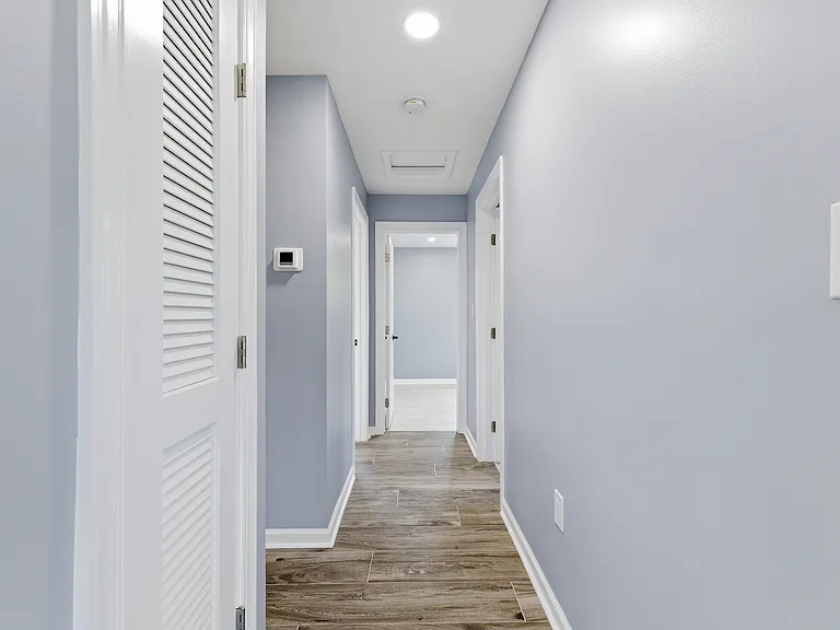 Hallway to bathroom and bedrooms from living room.