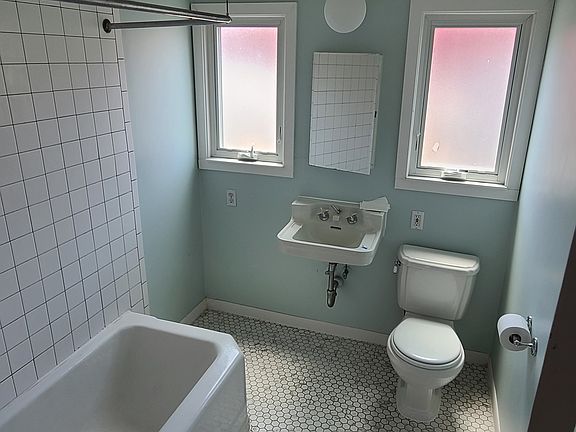 large bathroom with new tile floor. big windows with lots of natural light