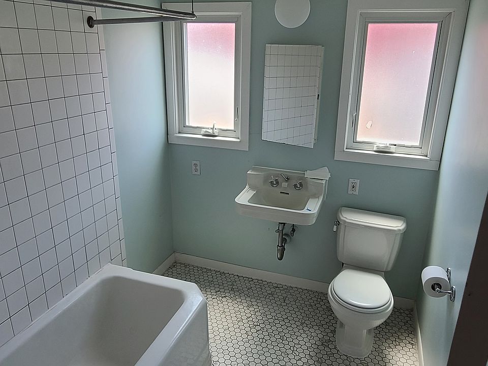 large bathroom with new tile floor. big windows with lots of natural light