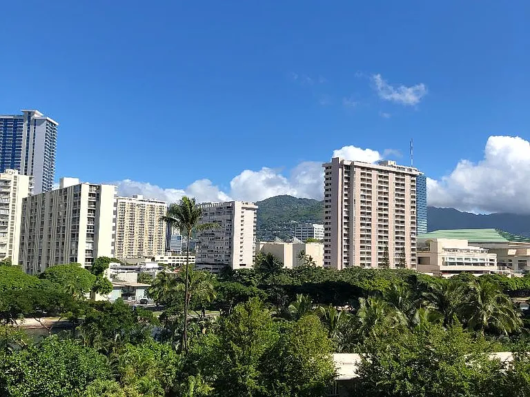 Mountainside Patio with breezes from Manoa Valley. Hawaii Convention center in background with green roof