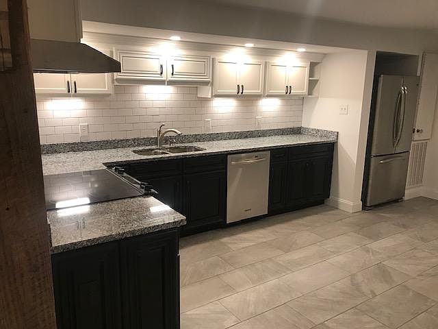Kitchen with gray granite counter tops.