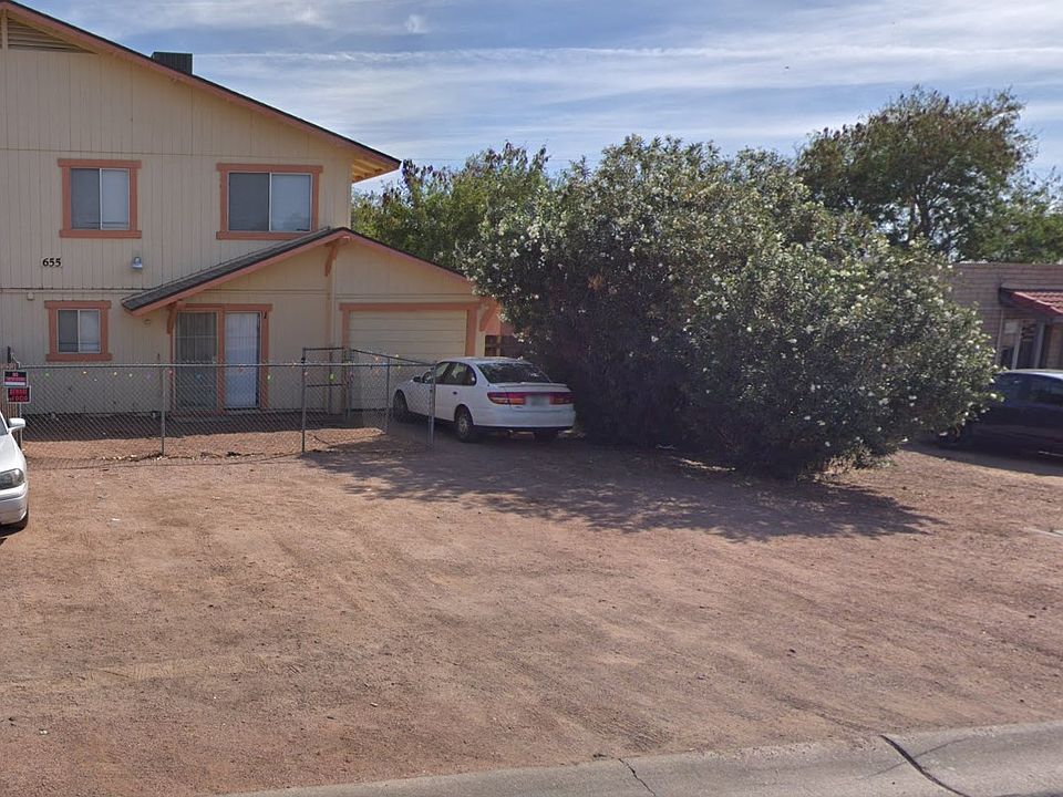 Front of building, with yard and parking area