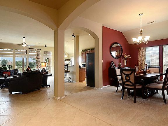 The Foyer extends to the Formal Dining Room and then opens to the Family Room, both delineated by large graceful arches