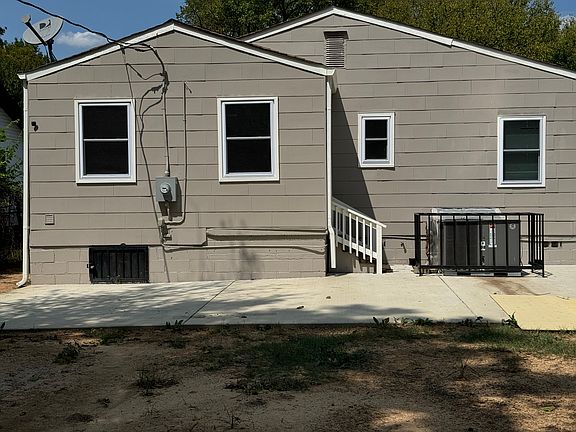 rear of house. Concrete patio added for entertaining. back door leads to oversized laundry room. Also has outside motion detection lights and camera