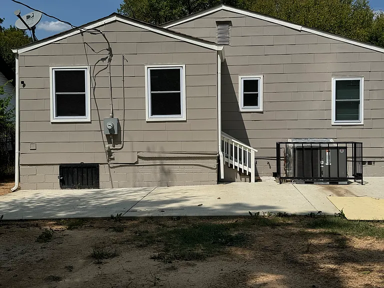 rear of house. Concrete patio added for entertaining. back door leads to oversized laundry room. Also has outside motion detection lights and camera