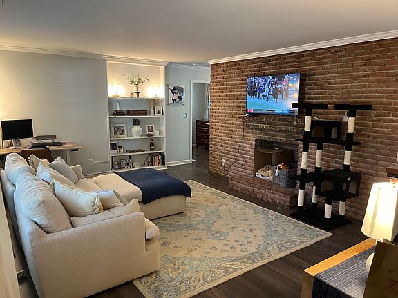Living area with TV mounted over fireplace