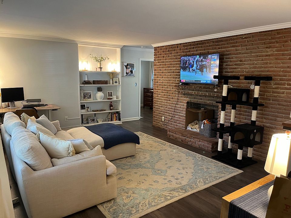 Living area with TV mounted over fireplace