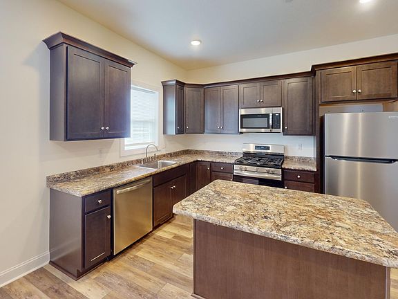 Kitchen Area w Stainless Steel Appliances and gas stove and Island