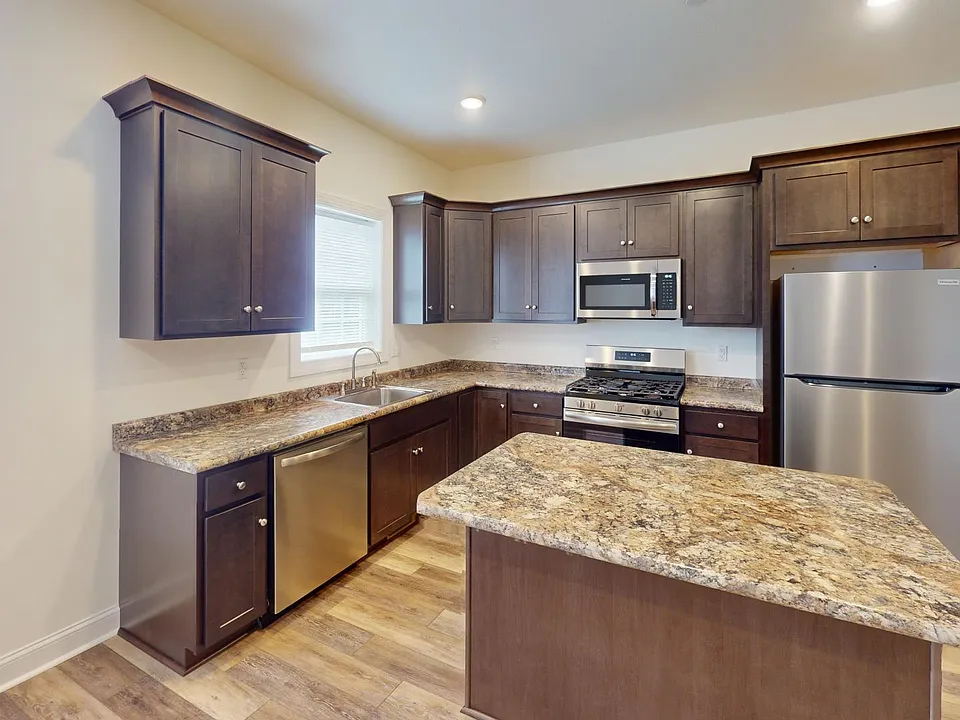 Kitchen Area w Stainless Steel Appliances and gas stove and Island