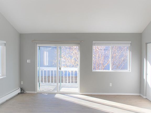 Living room with large closet for storage and sliding glass door that leads to private yard