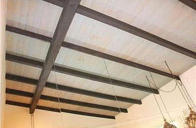 Great Room Wood beam ceiling with mirrored wall.