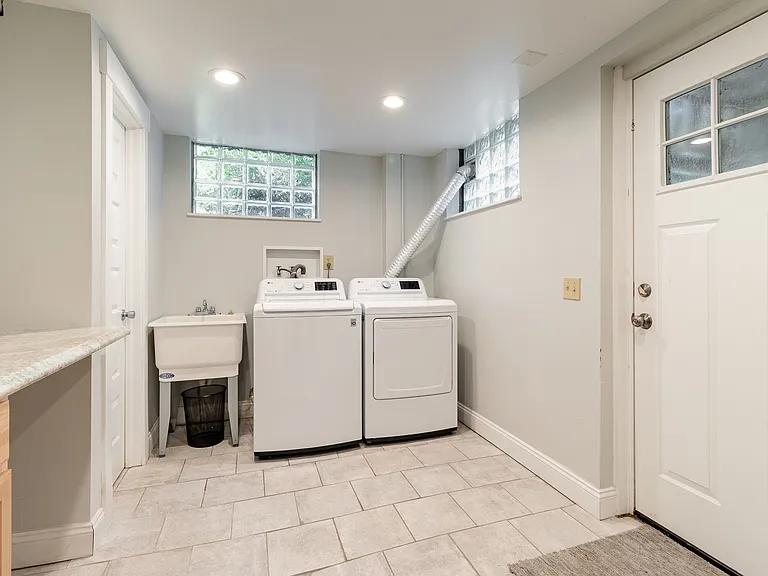 Full laundry on the bottom floor with attached 1/2 bath