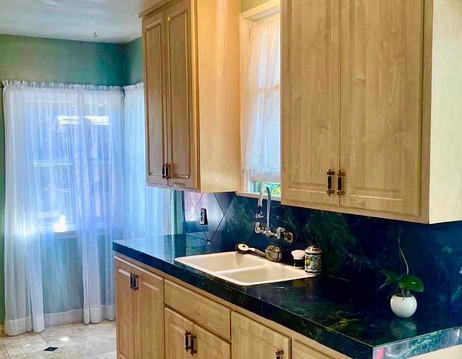 Kitchen with green natural marble stone countertop