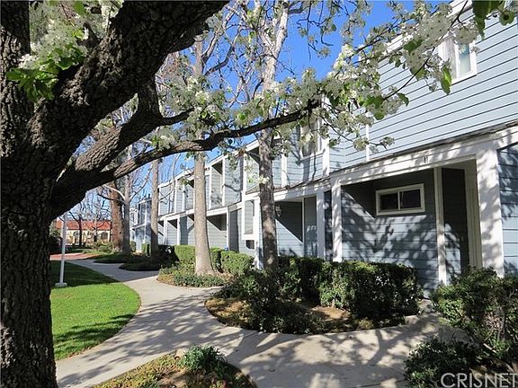 Beautiful grounds lead up to this upgraded townhome.