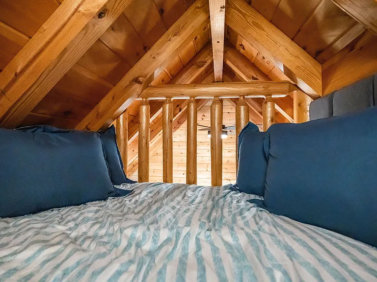 Twin bed in the loft accessible by ladder. Shares room with two queen beds below.