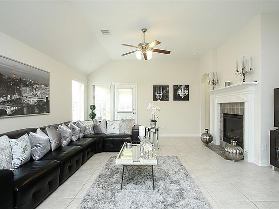 NOTE THE ARCHITECTURAL INTEREST IN THE HIGH CEILING WITH CEILING FAN. WINTER WILL BE A TIME TO ENJOY THE COZY GAS LOG FIREPLACE. PLENTY OF WINDOWS TO MAKE THE KITCHEN, FAMILY ROOM LIGHT AND BRIGHT! TILE FOR EASY CLEAN! THE BUILDER SEEMS TO HAVE TRIED