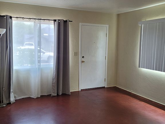 Living room front door and windows. Photo taken July 2026.