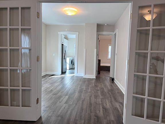 Looking from front room into the middle room of first floor.