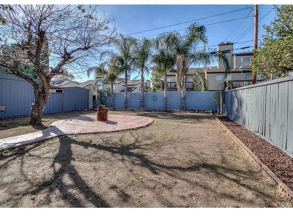 Big backyard with avocado tree, lime tree, and honey peach t